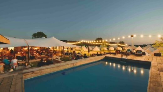 The pool and bar at The Pop-Up Hotel at dusk, during Glastonbury